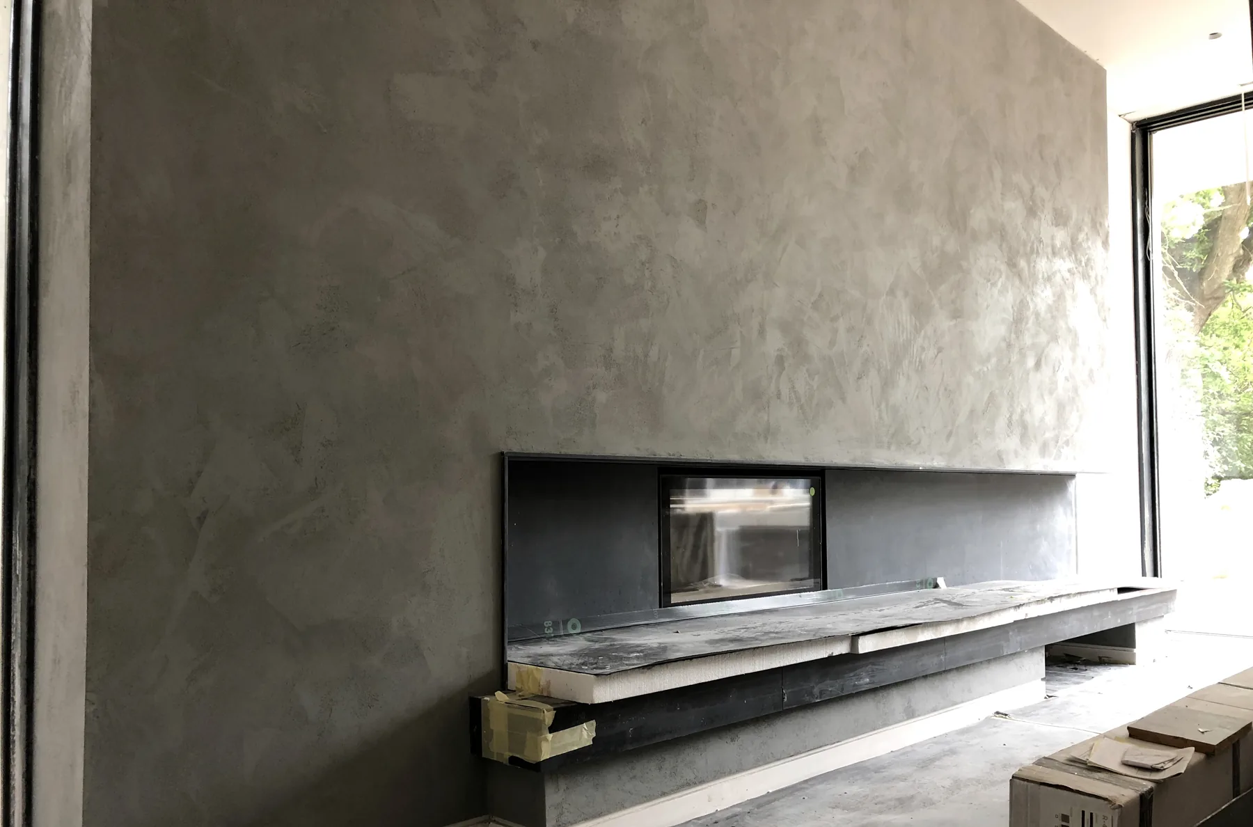 Grey marmorino feature wall with fireplace