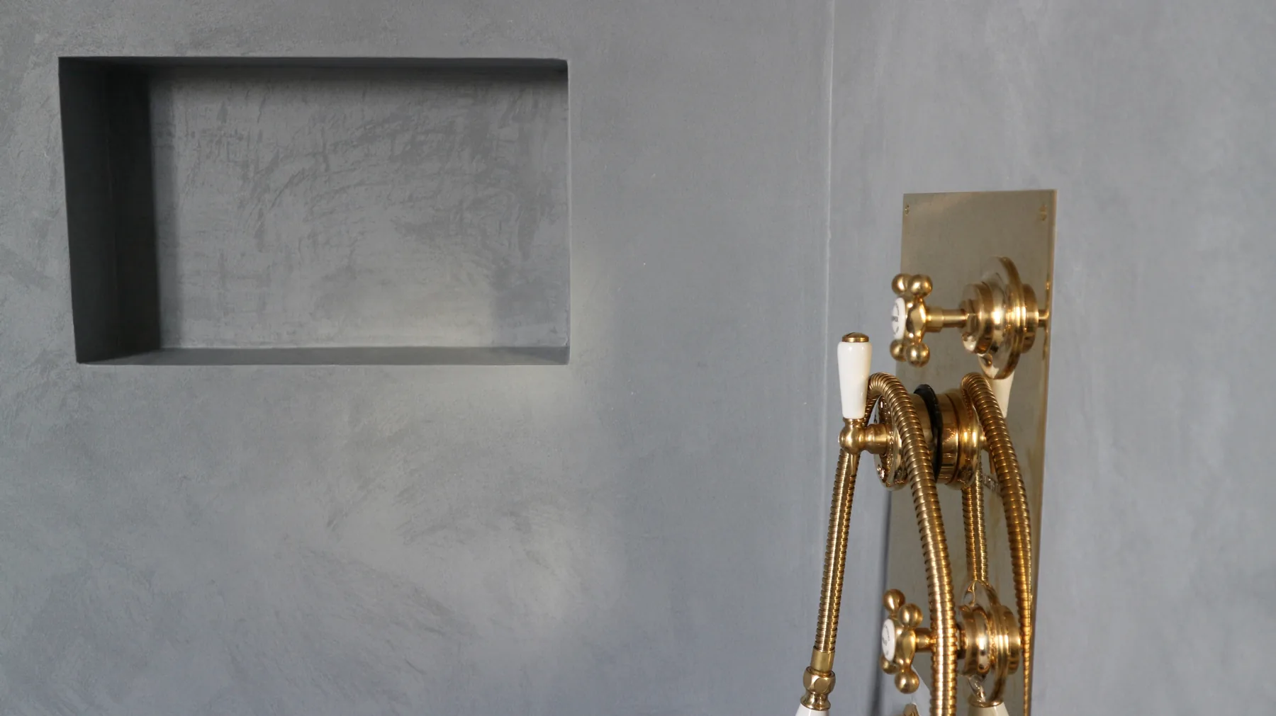 Microcement shower niche with brass fittings