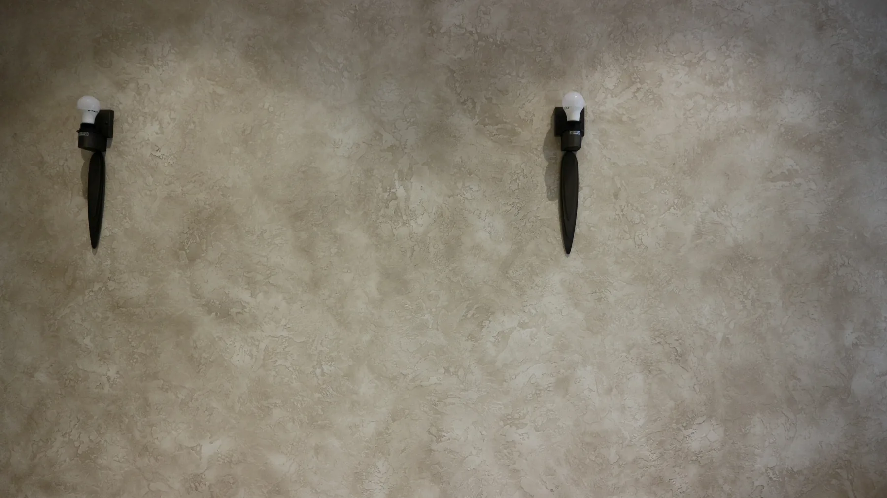 Travertine plaster wall with wall lights